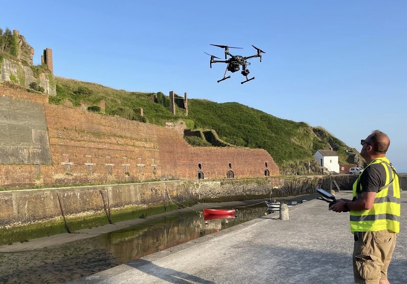 A surveyor piloting a drone